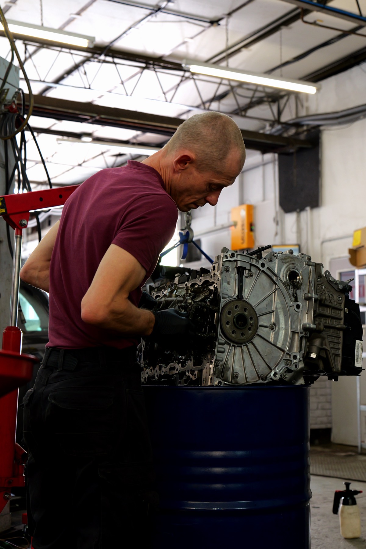 A Crown Garage technician working on an engine and gearbox in the workshop